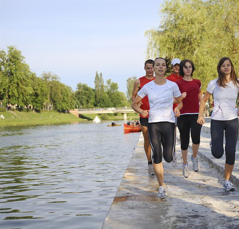 Picture of people running along side a river